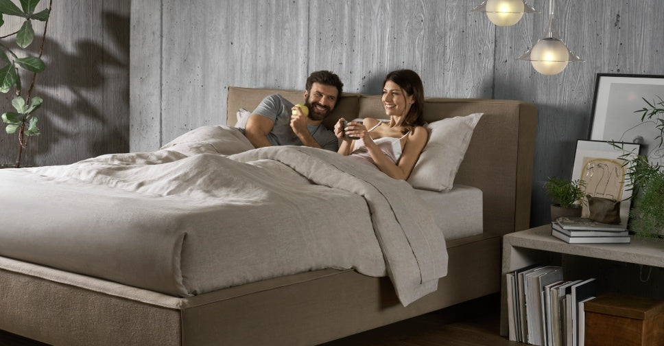 Couple at bed smiling