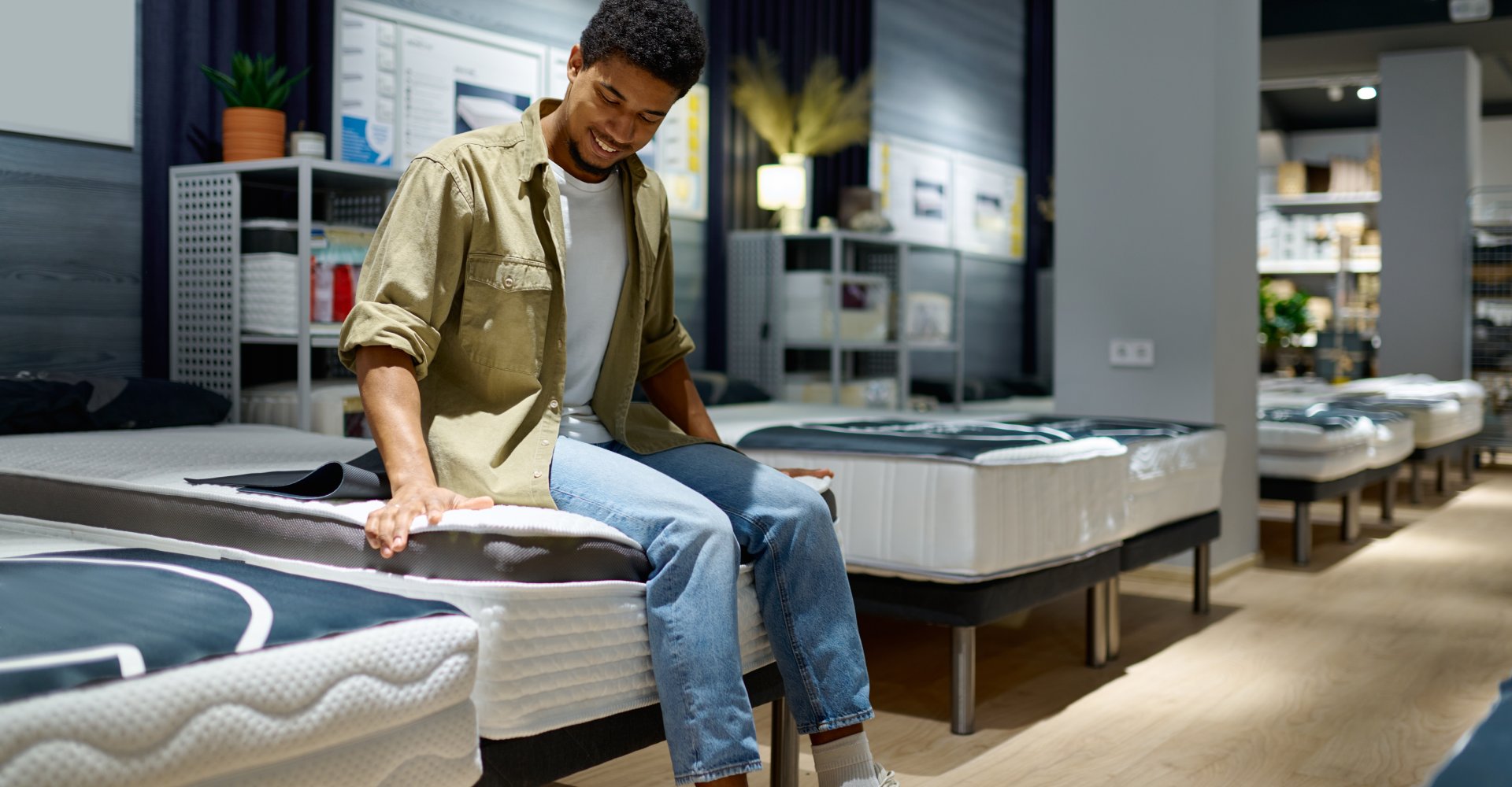 a person checking the firmness of a mattress